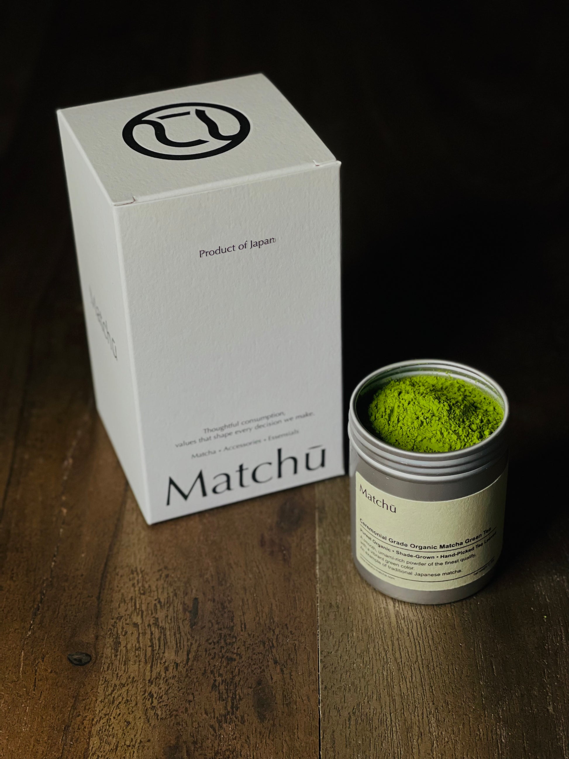 Matchu Matcha green tea powder in a canister with packaging on a wooden surface 20g